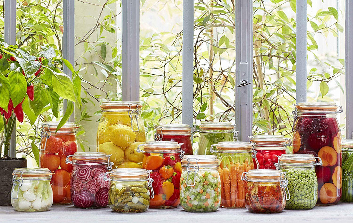 Le Parfait glass jars of preserved fruit and vegetables on a sunny kitchen windowsill