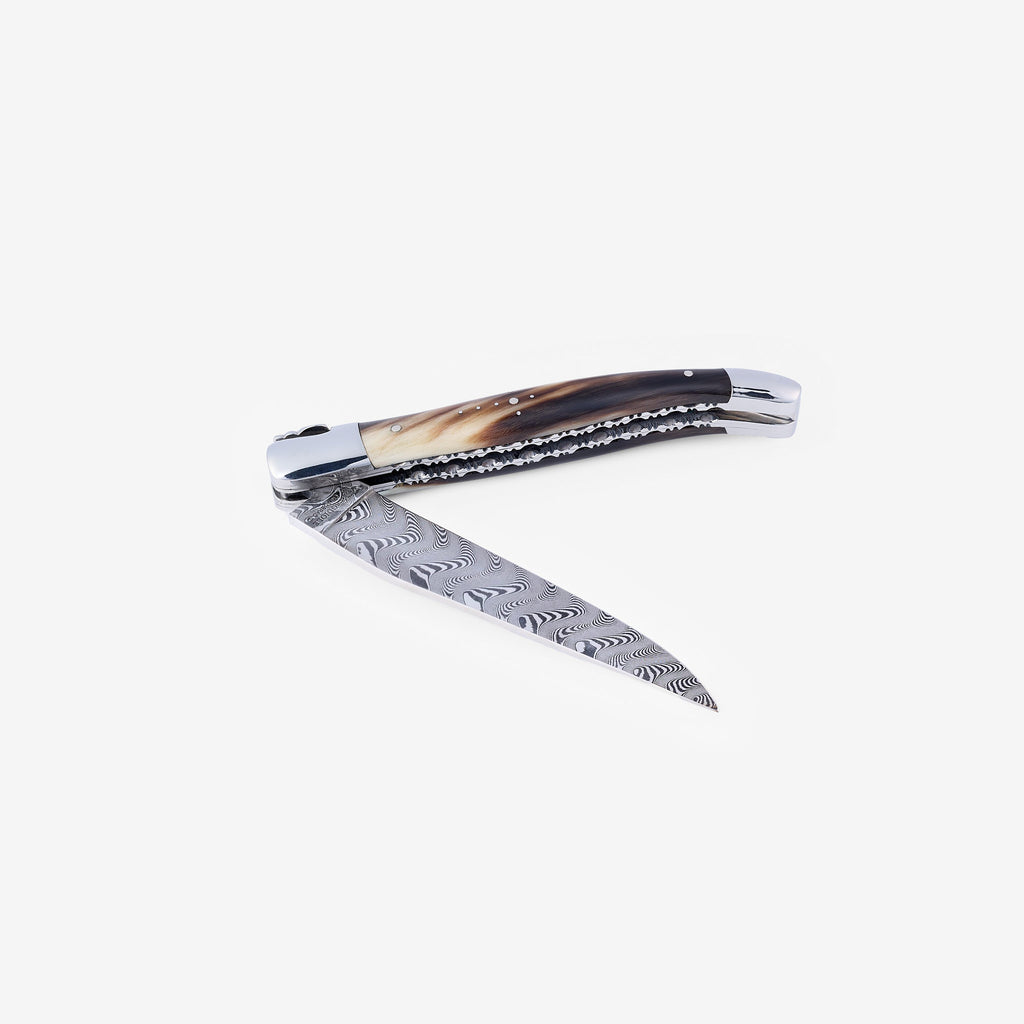 Knife half open with the Damascus blade angled down