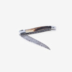Knife half open with the Damascus blade angled down