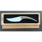 Le Buron cheese knife in its open oak box on a dark table