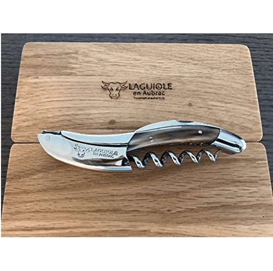 Solid horn corkscrew resting on the engraved Laguiole en Aubrac oak lid