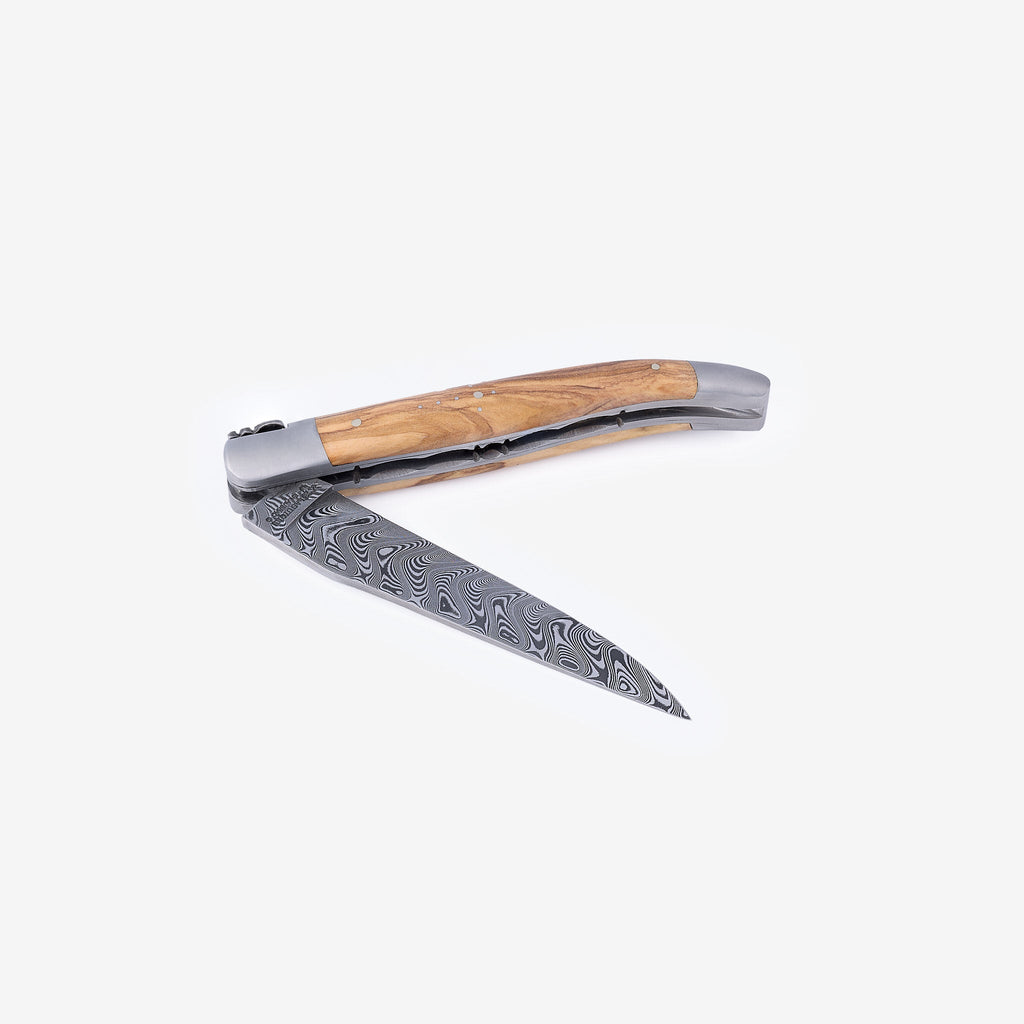 Knife half open with the Damascus blade pointing down