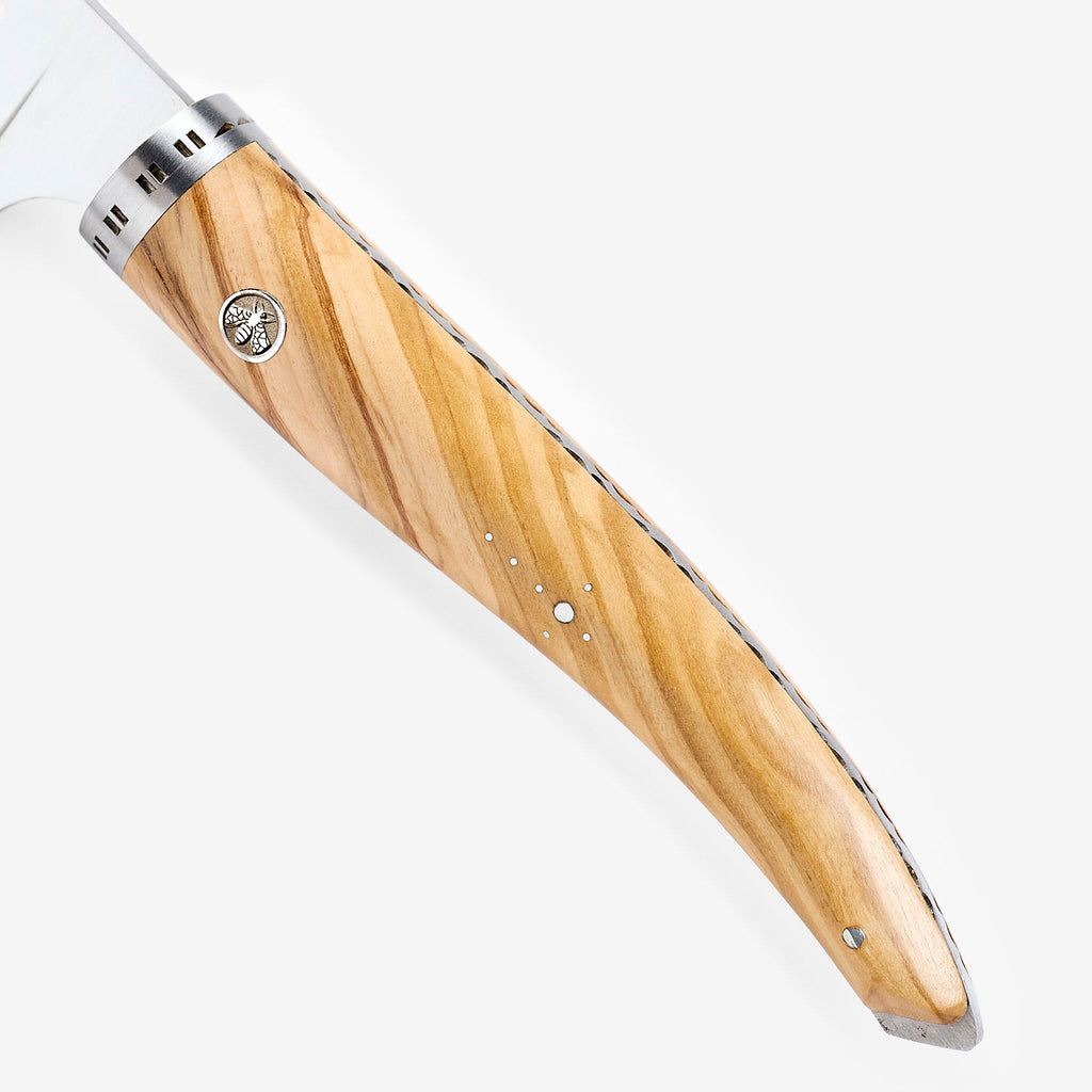 Close view of the olive wood grain, rivet and bolster