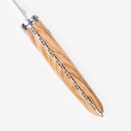 Close view of the olive wood handle and decorated spine from above