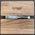 Side view of the folded corkscrew on the closed oak box