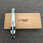 Folded checkerboard corkscrew standing upright on the oak box