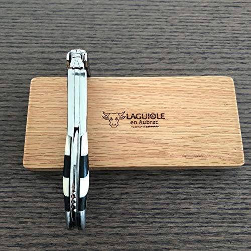 Folded checkerboard corkscrew standing upright on the oak box