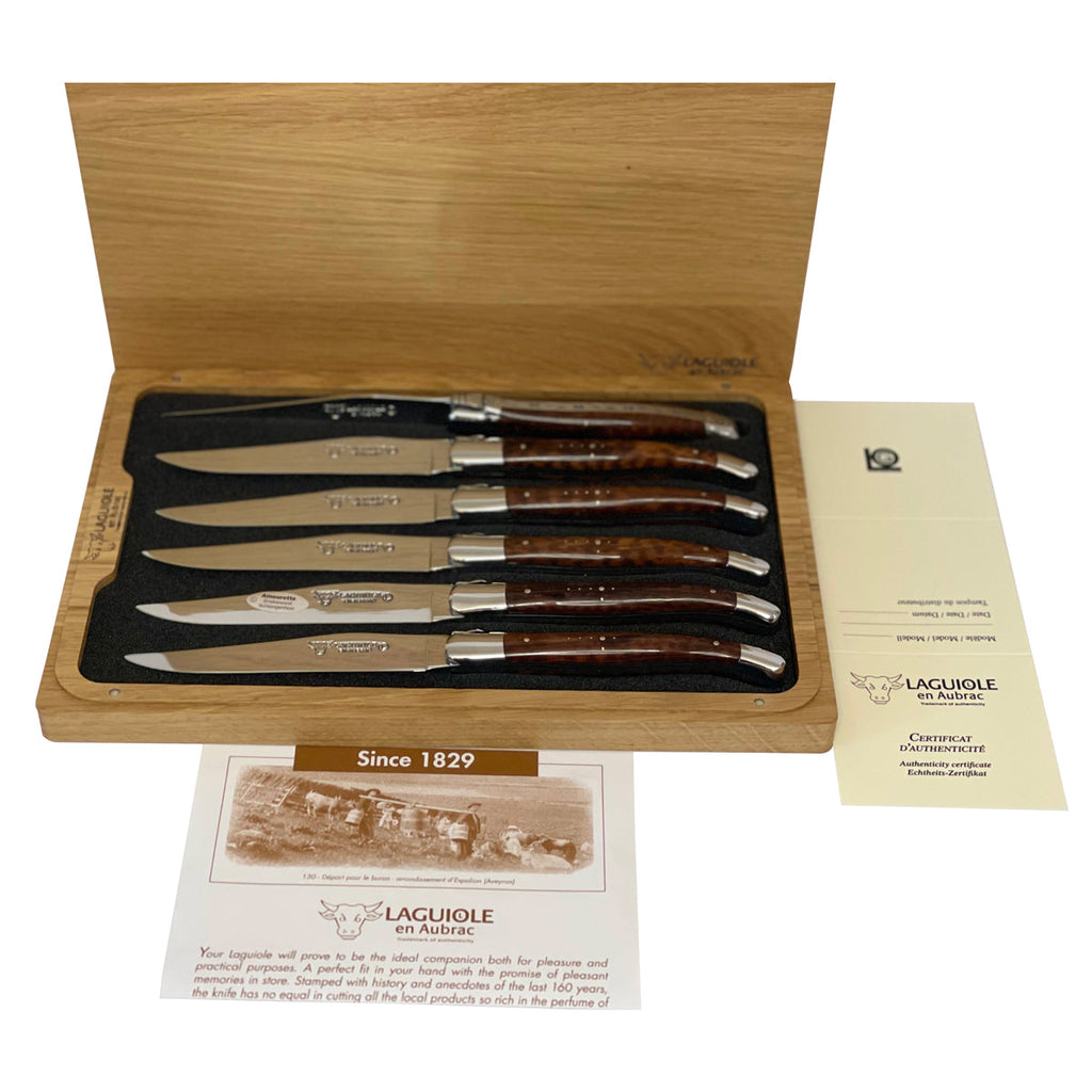 Boxed set with lid open above the certificate and booklet