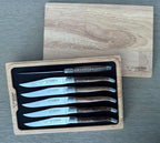Boxed set with the lid set behind on a grey surface