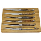 Six knives laid on the box lid showing the range of burl colours