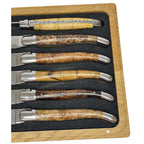 Close view of the burl handles and shiny bolsters in the foam tray