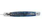 Close view of the carved spine along a blue burl handle