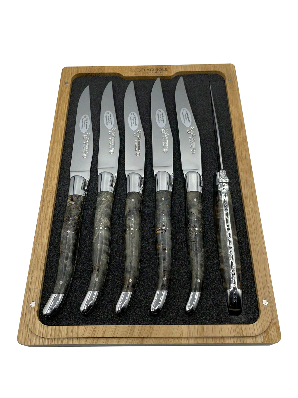 Six smoky burl handled knives standing upright in the foam tray