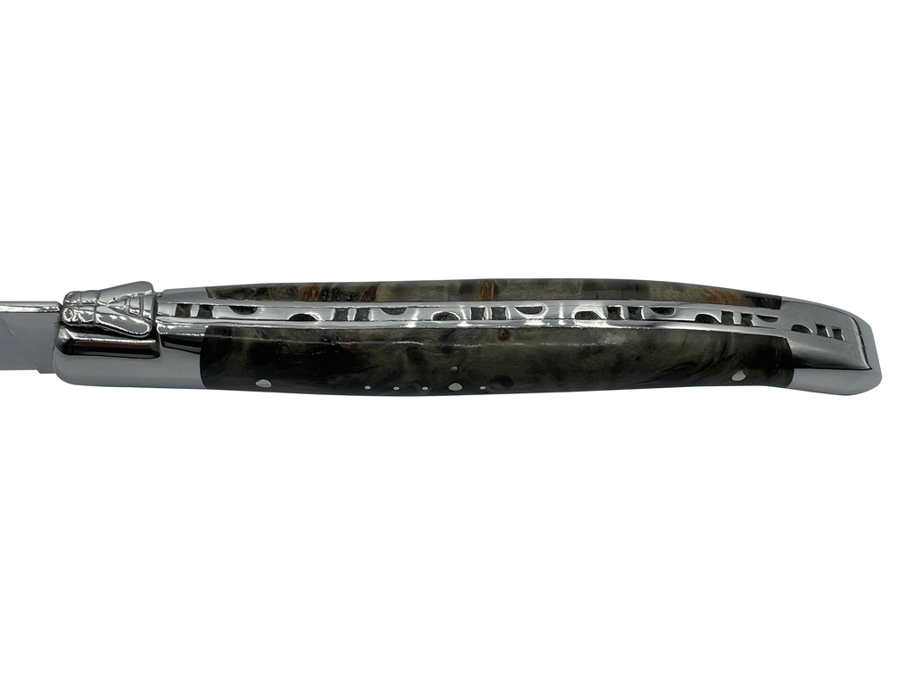 Close view of the carved spine along the burl handle