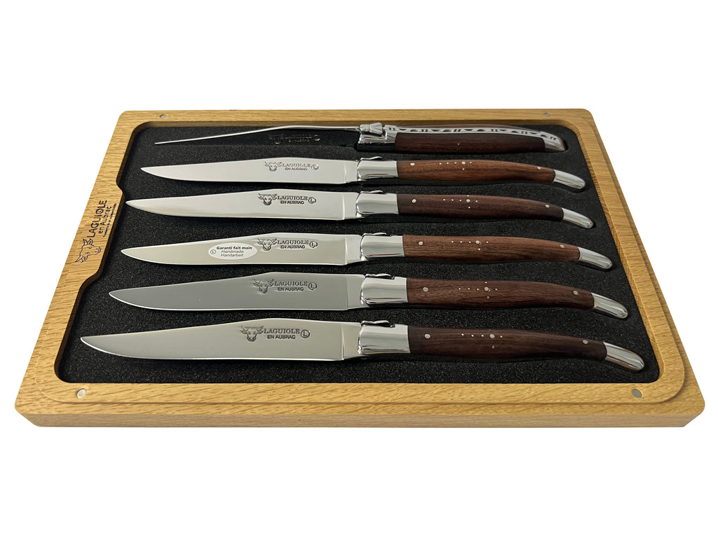 Rosewood knives lying in the foam tray of the open box