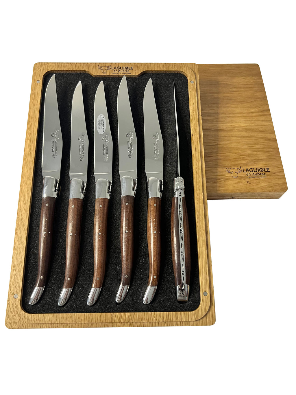 Open box with six knives standing upright and the lid beside