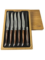 Open box with six knives standing upright and the lid beside