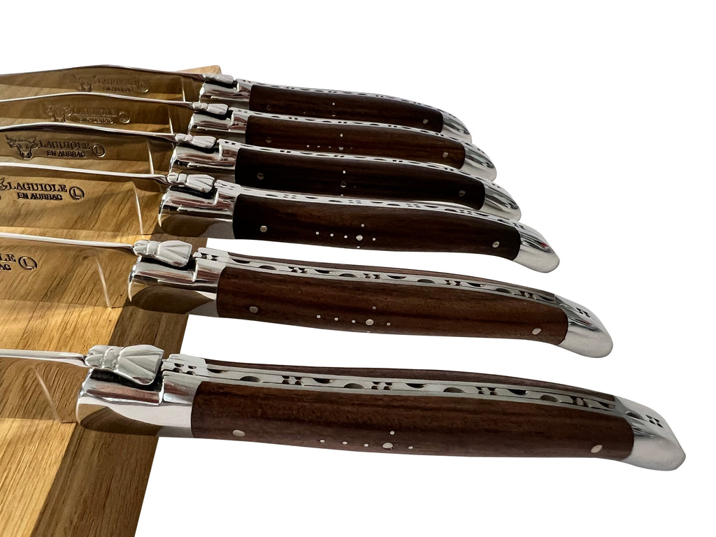 Close view of the knives fanned out showing carved spines