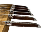 Close view of the knives fanned out showing carved spines