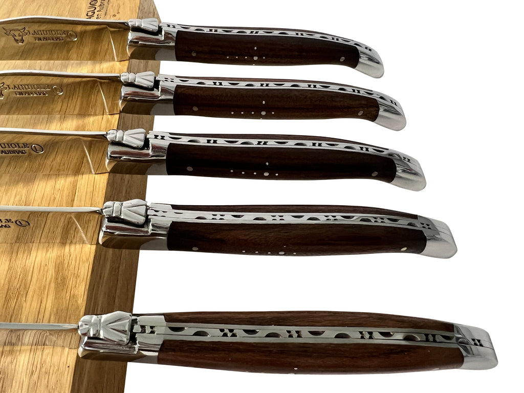 Close view of rosewood handles and polished bolsters
