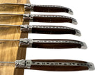 Close view of rosewood handles and polished bolsters