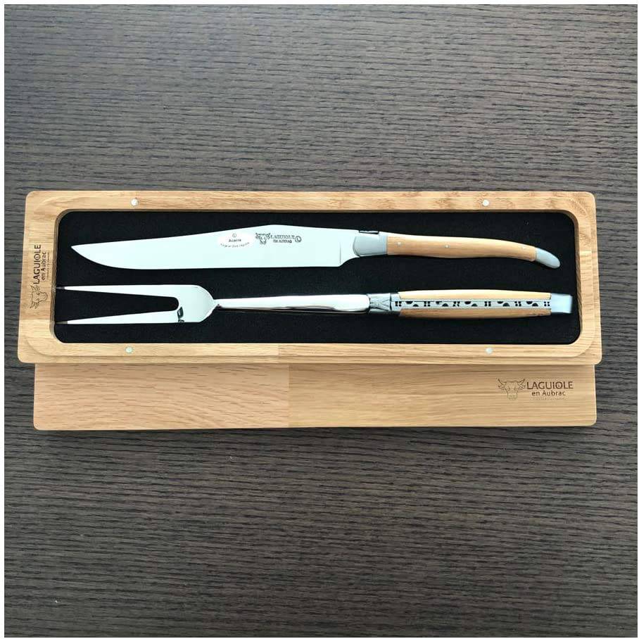 Boxed carving set on a dark wood surface