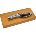 Folded corkscrew lying on top of its oak box
