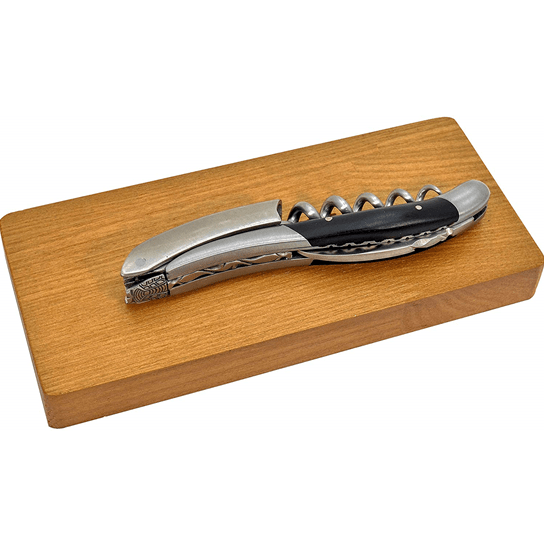 Folded corkscrew lying on top of its oak box