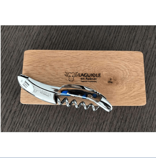 Corkscrew resting on the Laguiole en Aubrac oak box on a dark table