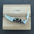 Corkscrew with foil cutter open resting on the Laguiole en Aubrac oak lid