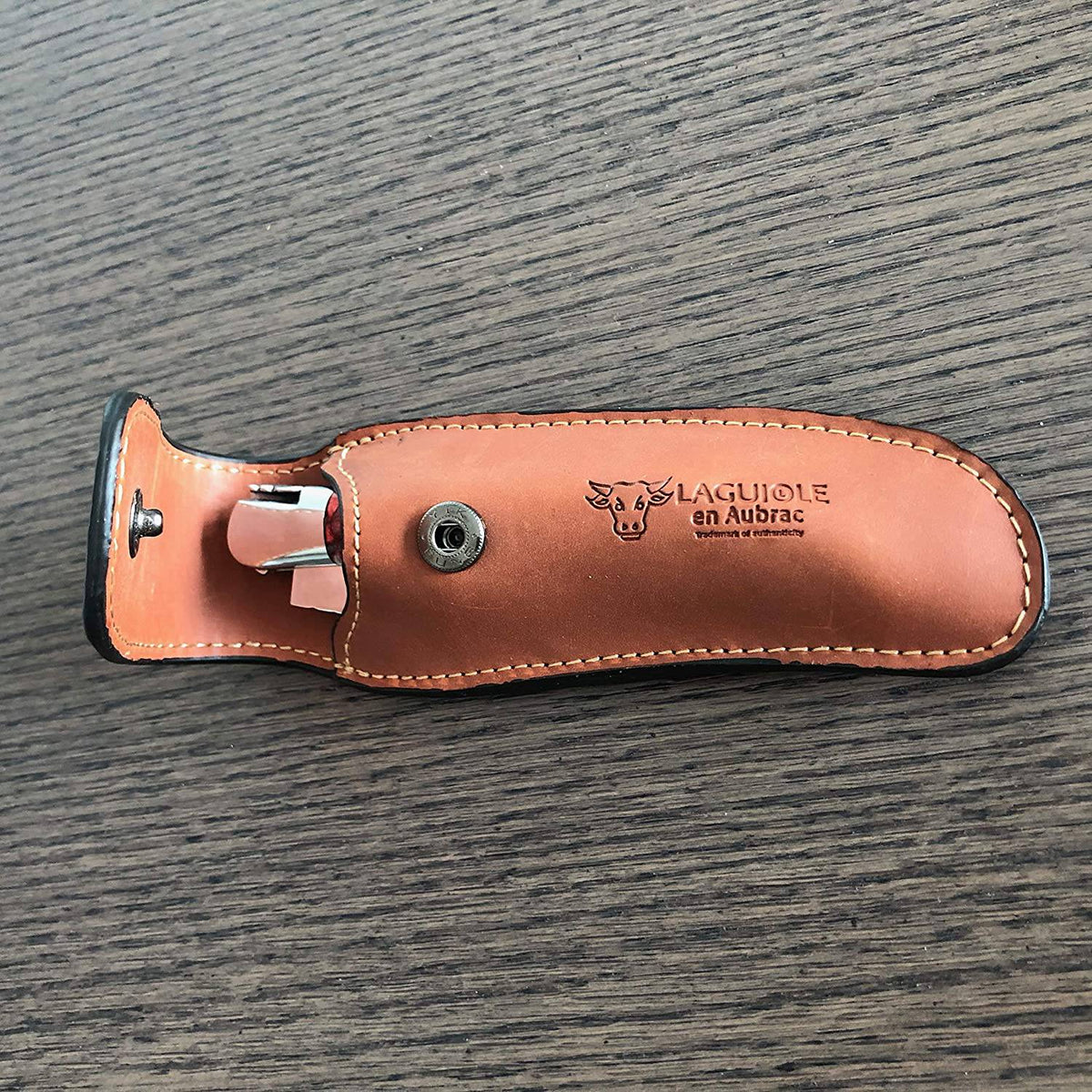 Back of the brown sheath showing the belt opening and snap