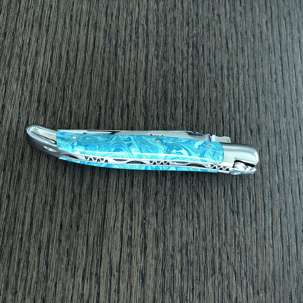 Closed Larimar knife showing the worked spring and bee