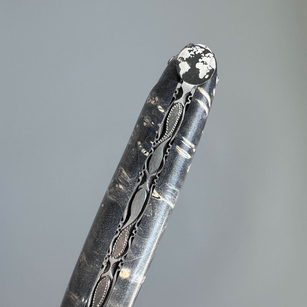 Close view of the Earth bee at the end of the dark handle
