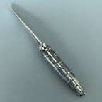 Open knife lying diagonally showing the engraved spring