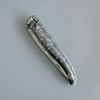 Closed dark burl knife at an angle