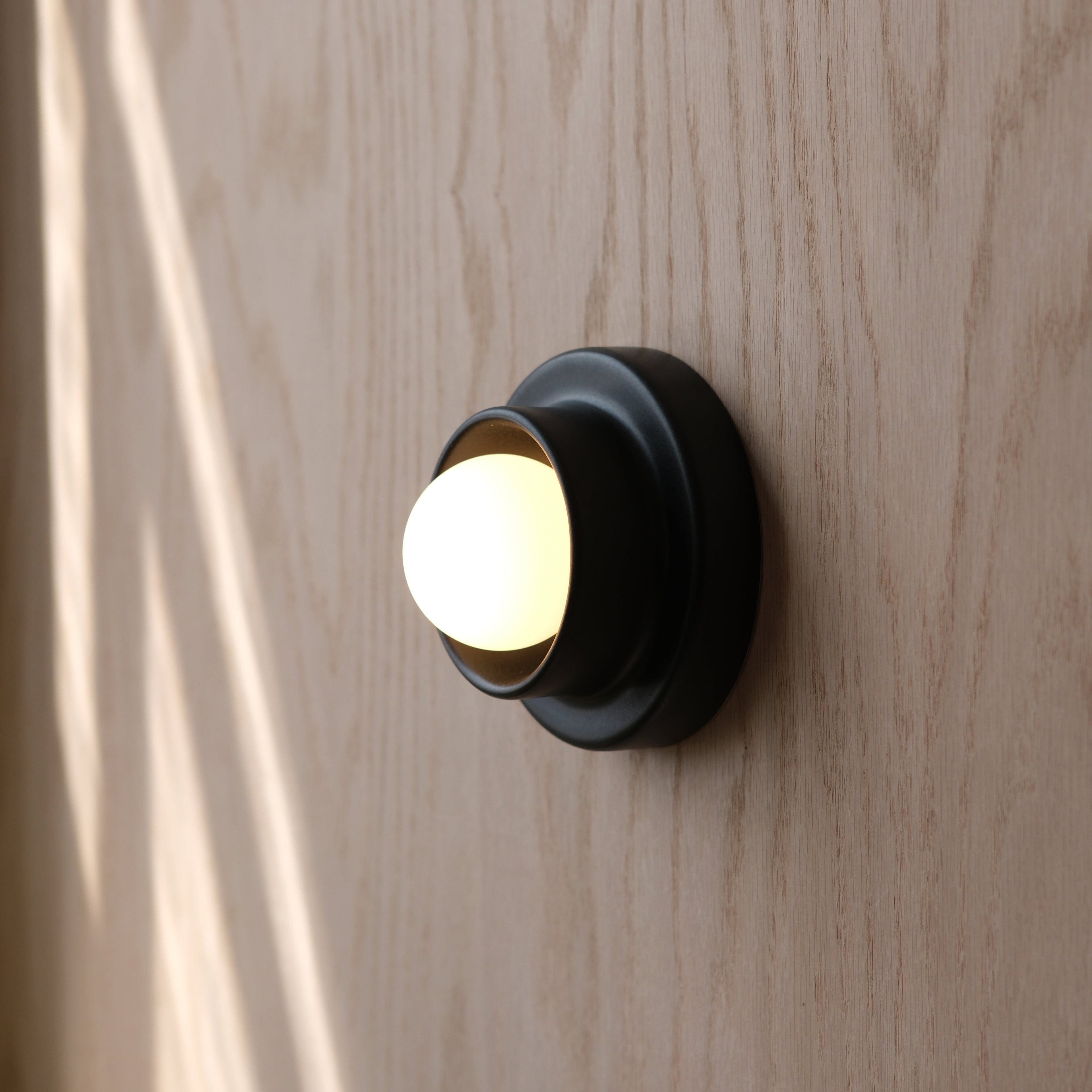 Misewell Q Sconce in Black with glass globe
