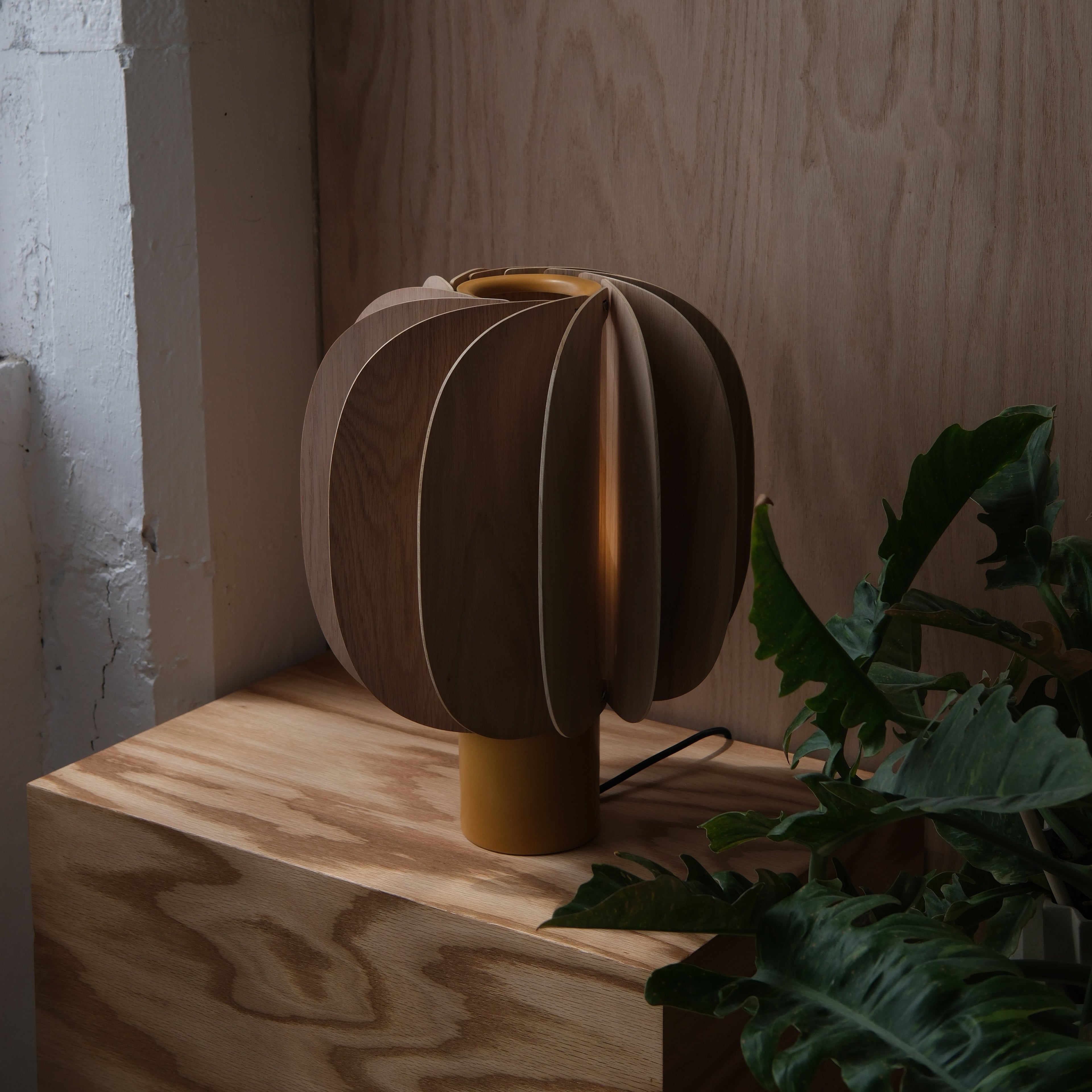 Fin Table Lamp scale next to seated armchair