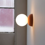 Monroe Sconce lit, warm 2700K light through globe