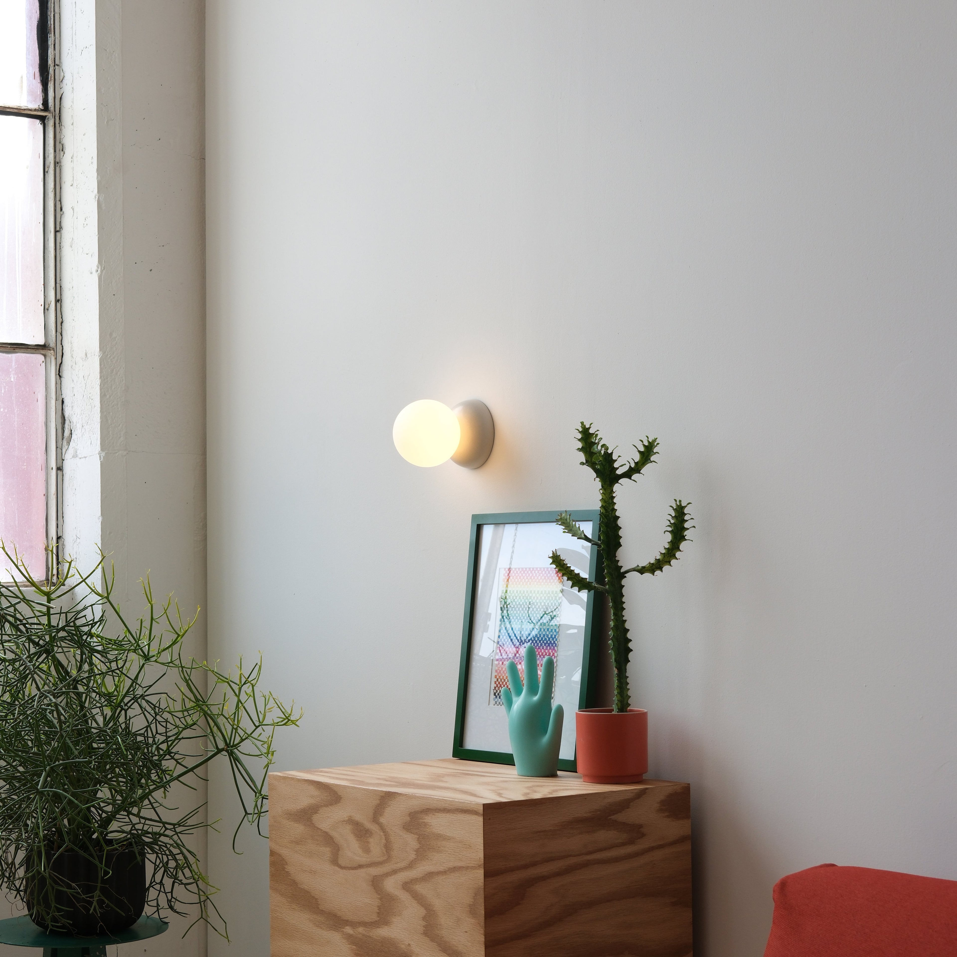 Monroe Sconce showing glass globe and ceramic body
