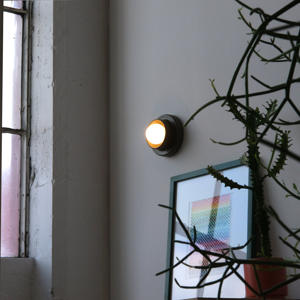 Q Sconce in Moss glaze installed beside a doorway