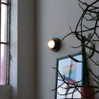 Q Sconce in Moss glaze installed beside a doorway