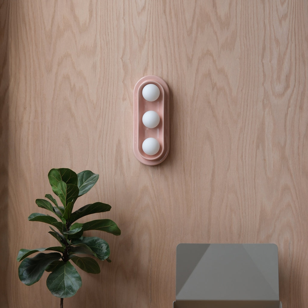 Q Triple Sconce in Dune mounted in a stairwell