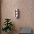 Q Triple Sconce in Dune mounted in a stairwell