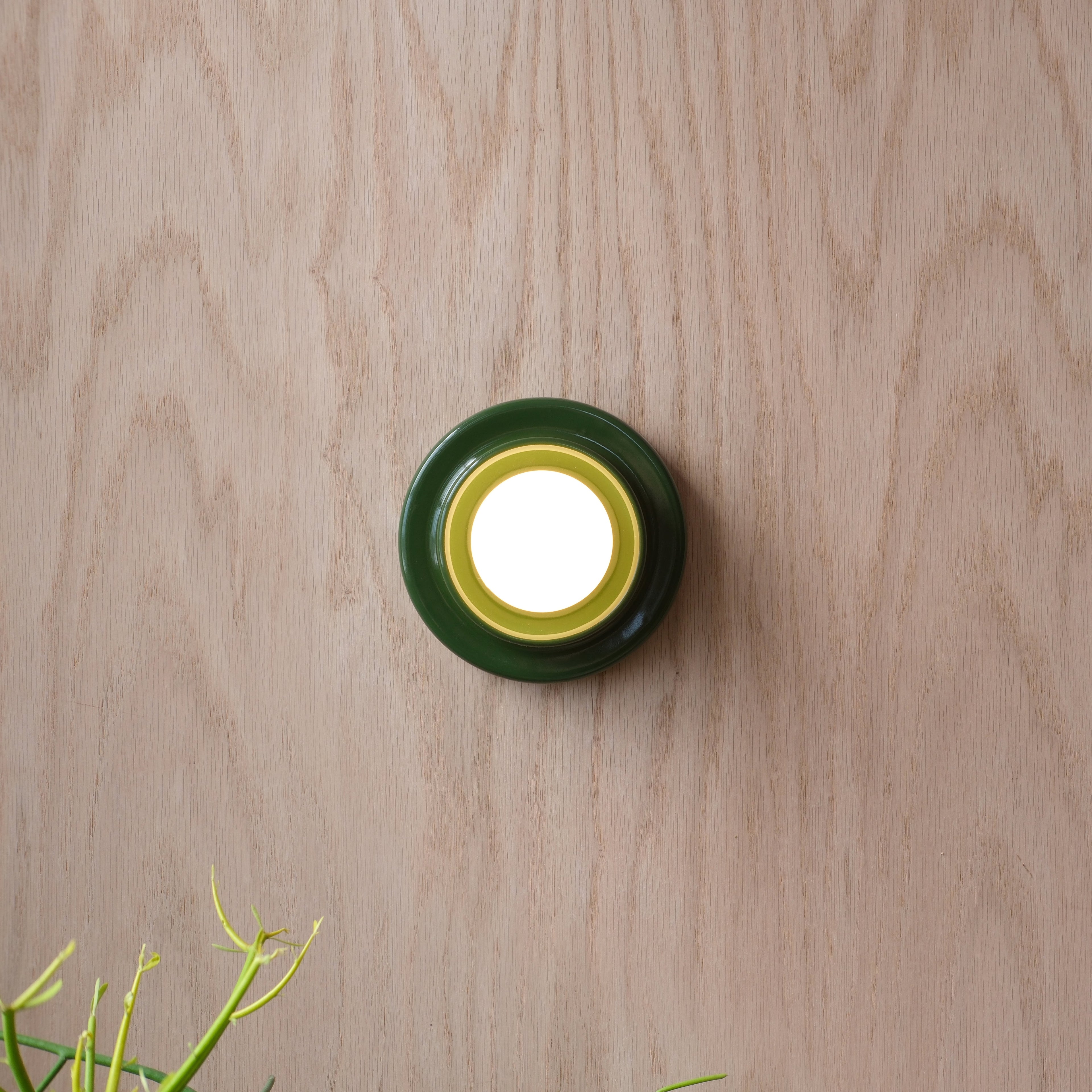 Q Sconce in White Glossy mounted on a hallway wall