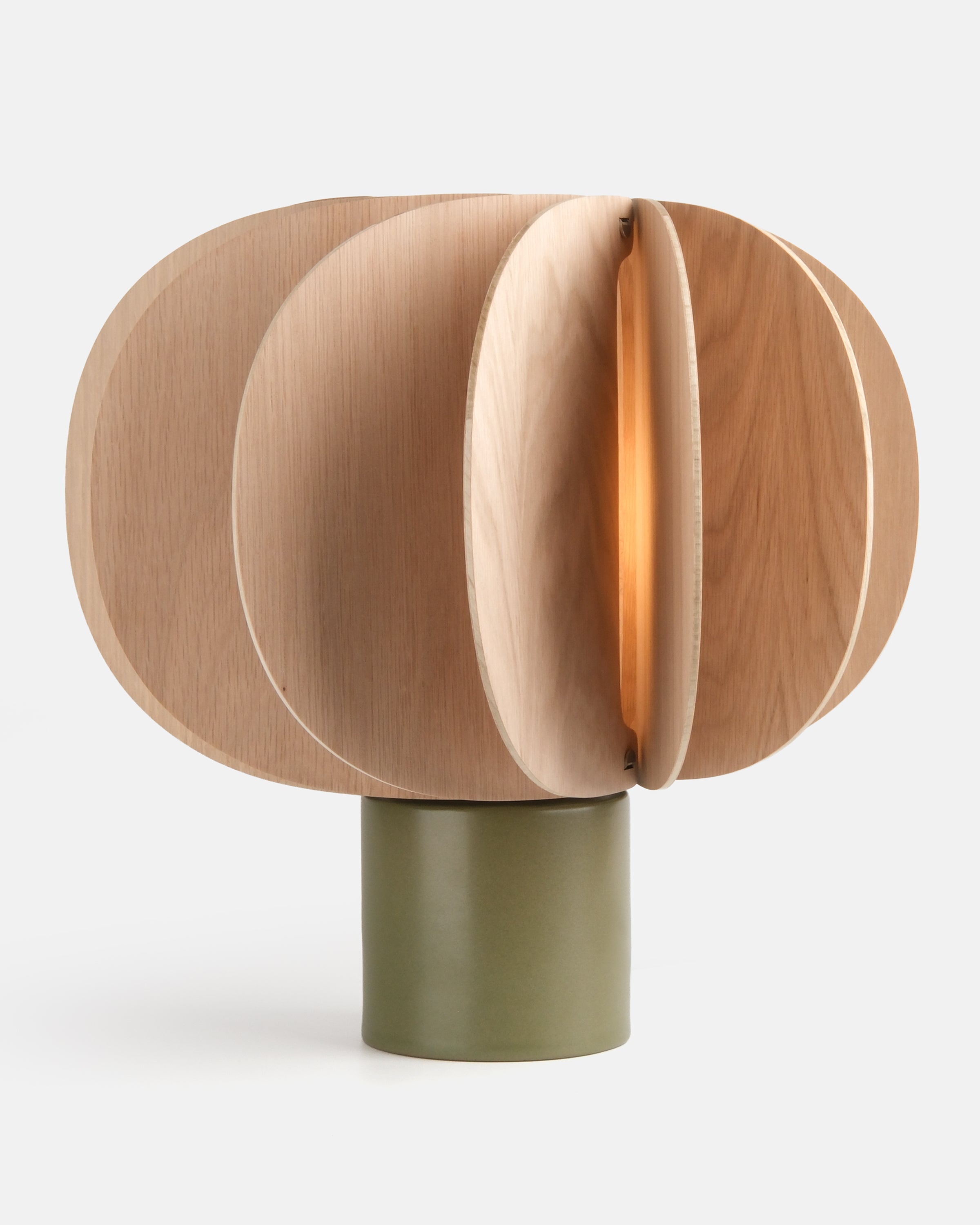 ceramic and wood table lamp in Moss glaze on a console