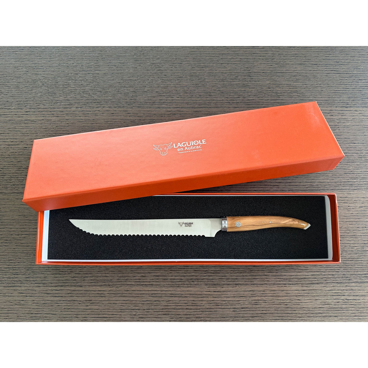 Bread knife in an open orange Laguiole en Aubrac gift box