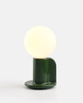 small ceramic accent lamp in Green glaze on a bookshelf