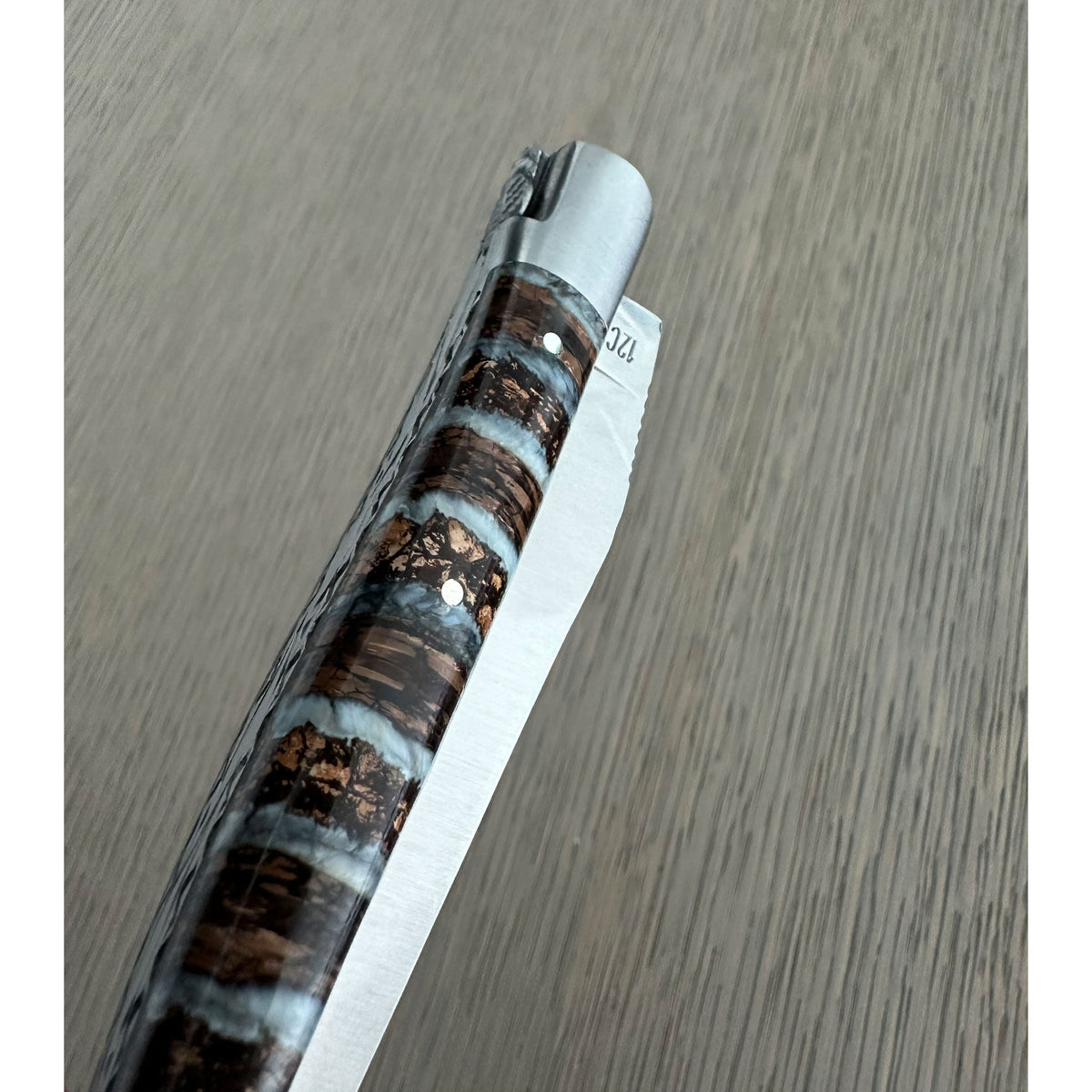 Close view of the banded handle and matte bolster