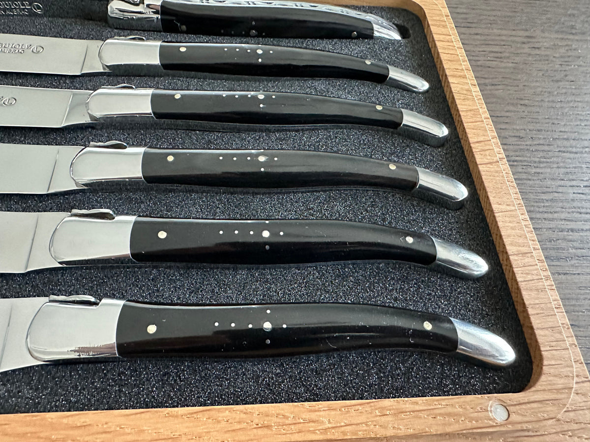 Close view of six horn handles and polished bolsters in the foam tray
