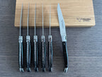 Six knives standing upright with one turned to show the blade